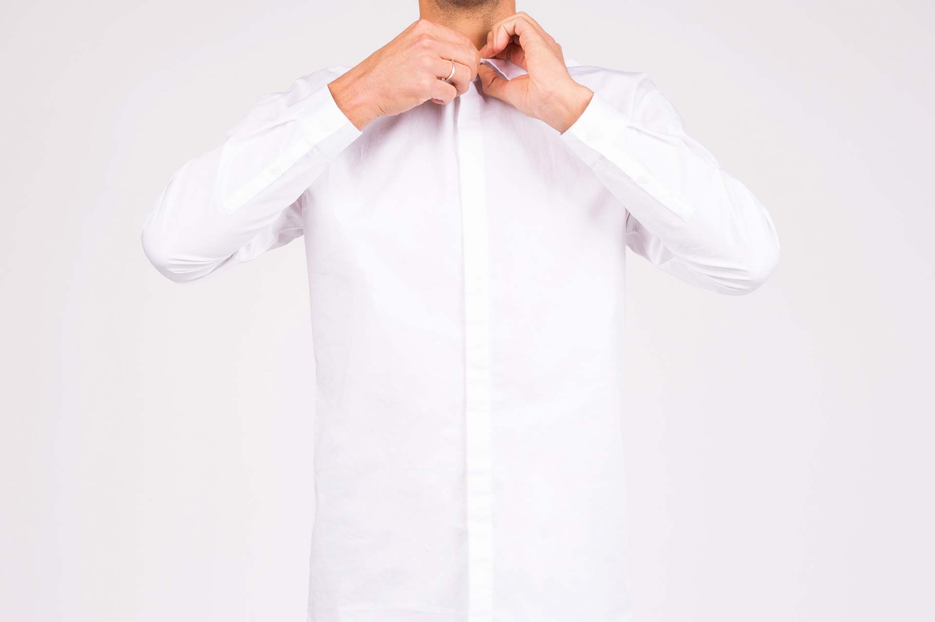 Man wearing freshly pressed dress shirt representing east bay dry cleaning delivery